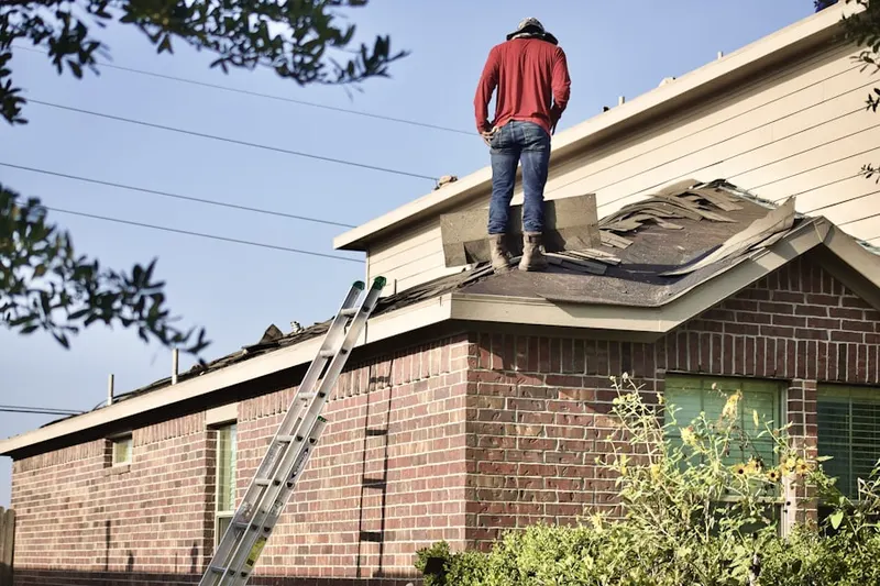 Professional roofer working on a residential roof in Farmton